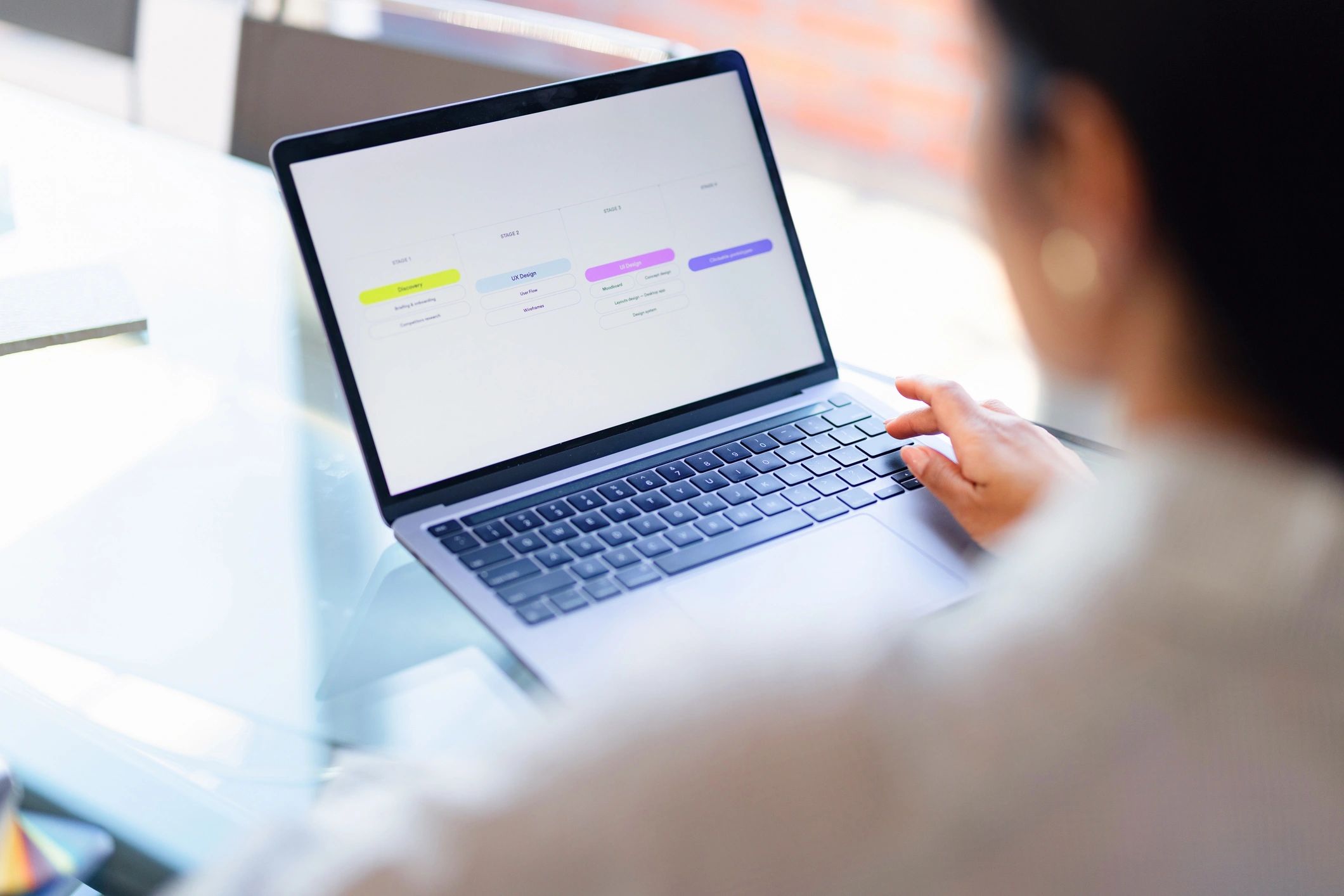 Businesswoman planning website workflow on a laptop in a bright office